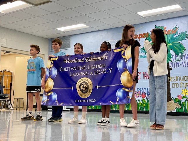 Students Holding Legacy Banner at Celebration